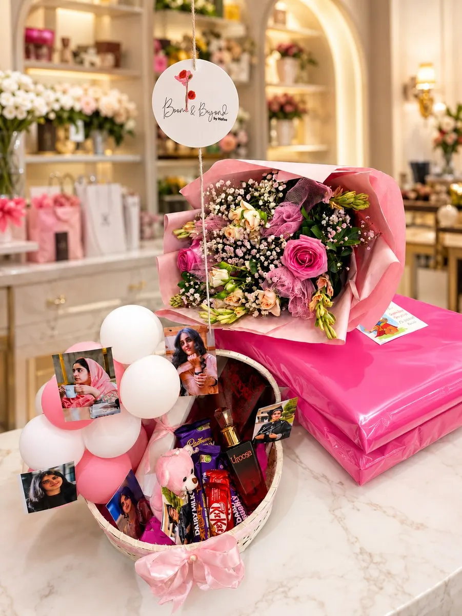 Photo-memory basket with balloons, chocolates and roses, handcrafted in Lahore alongside a wrapped laptop the sender supplied