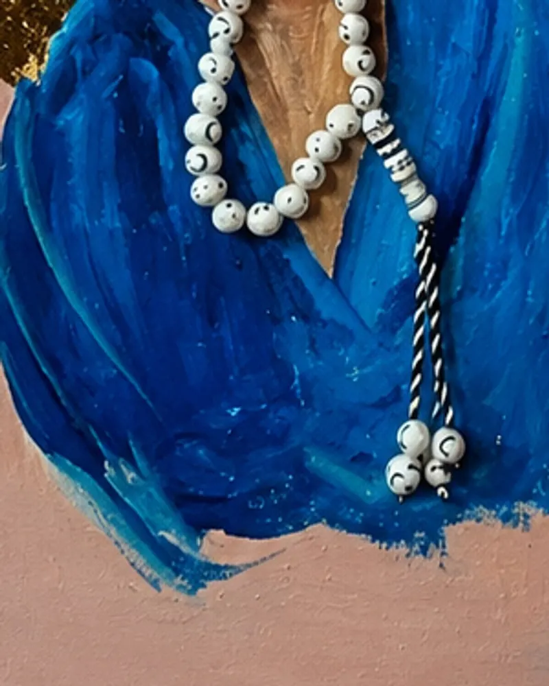 Detail of Hafsa Imran's Tasbih: the loosely brushed blue sleeves and the tassel of the prayer beads