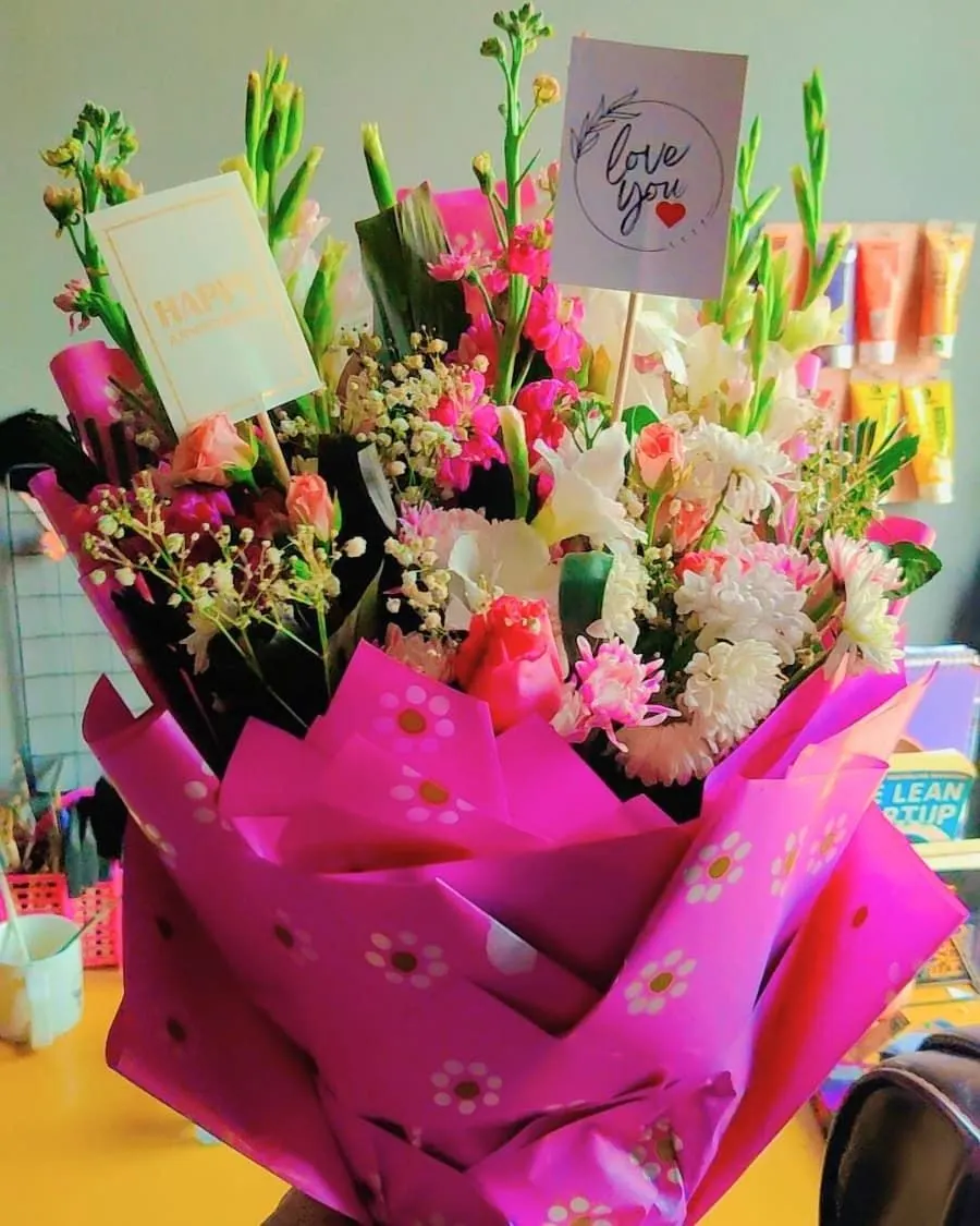 A romantic anniversary bouquet with gladiolus, pink blooms, and a handwritten 'Happy Anniversary' card — handcrafted by Bloom & Beyond in Lahore