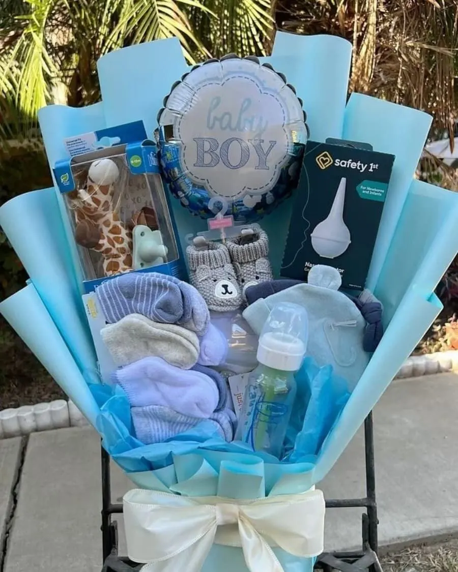 A blue-themed welcome basket for baby boys — with balloon, baby items, flowers, and soft decorations — handcrafted by Bloom & Beyond in Lahore