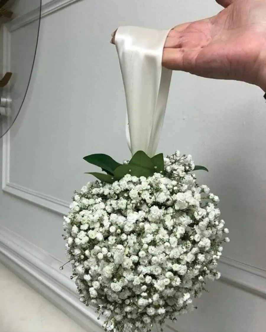 A charming sphere of white baby breath — also known as a pomander or kissing ball — handcrafted by Bloom & Beyond in Lahore