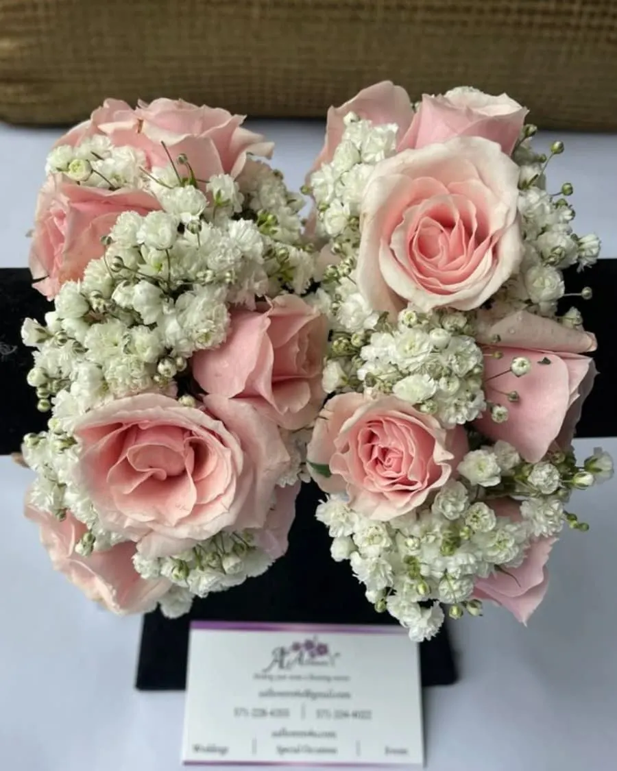 A matching set of three bridesmaid bouquets — pink roses with baby breath, wrapped in coordinating ribbon — handcrafted by Bloom & Beyond in Lahore