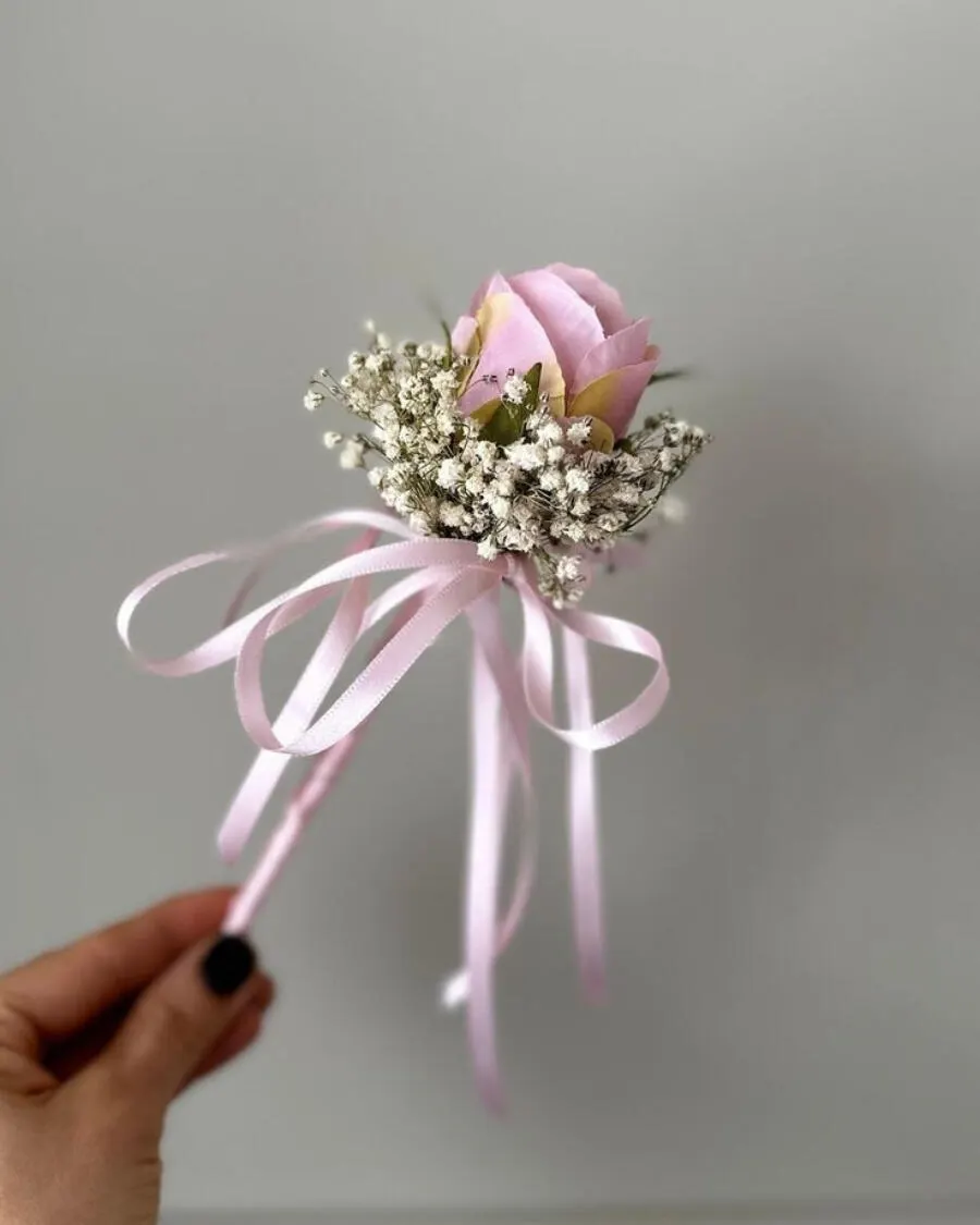 A sweet mini bouquet with a single pink rose surrounded by baby breath and tied with a satin ribbon — handcrafted by Bloom & Beyond in Lahore