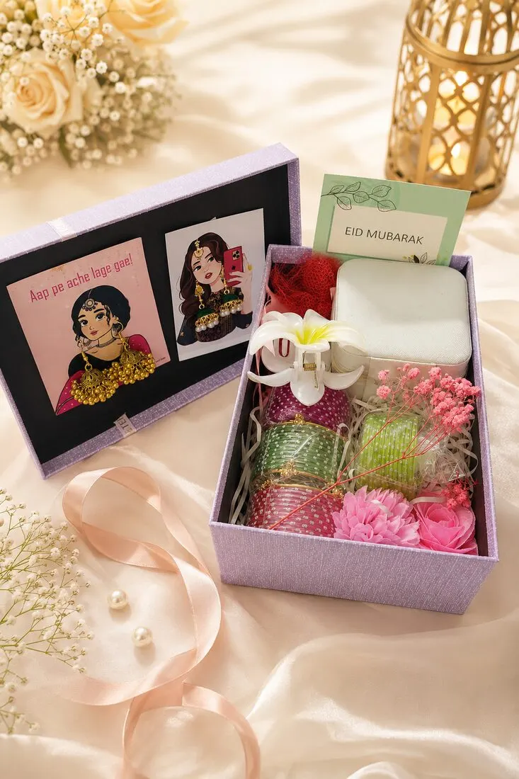 A sweet Eid gift box for children — playful illustrated cards, bangles, soap, a white lily and preserved pink blooms — handcrafted by Bloom & Beyond in Lahore