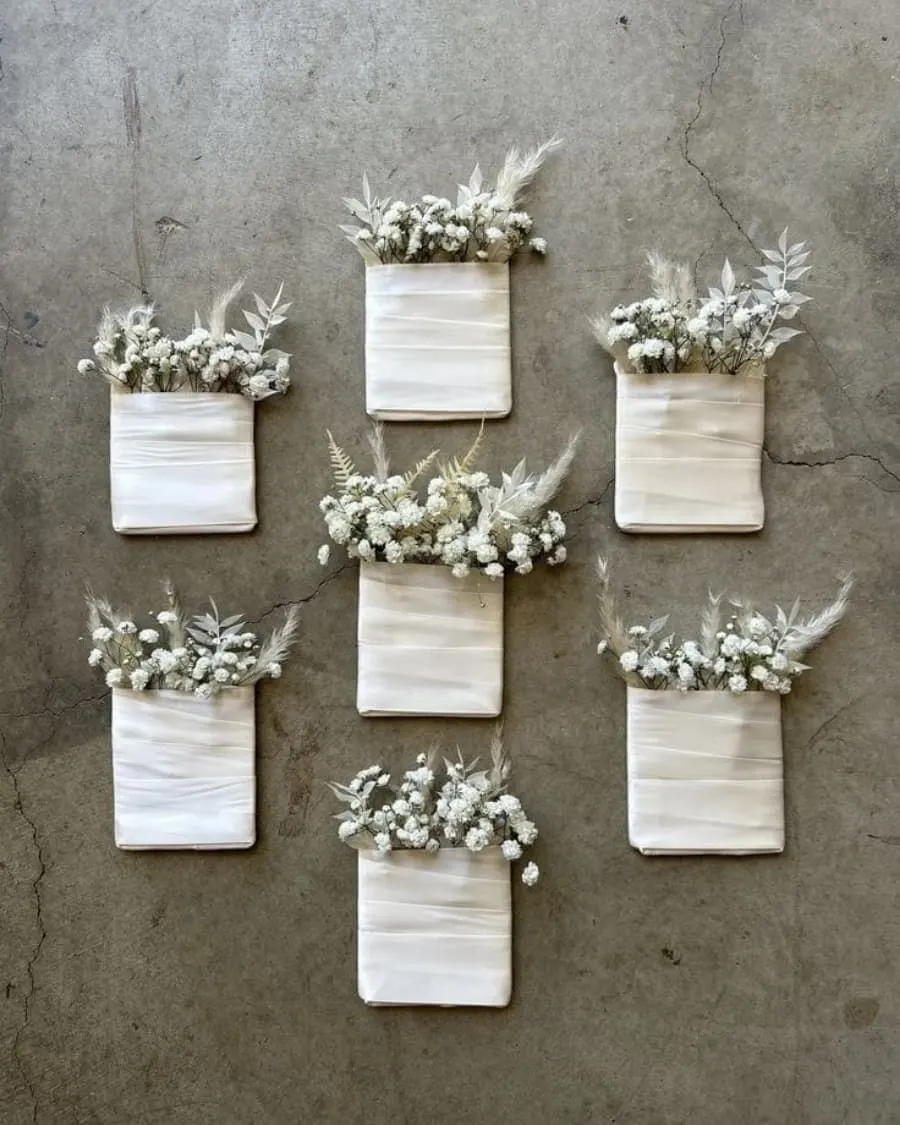 A set of three mini dried flower arrangements tucked in linen fabric pockets — handcrafted by Bloom & Beyond in Lahore