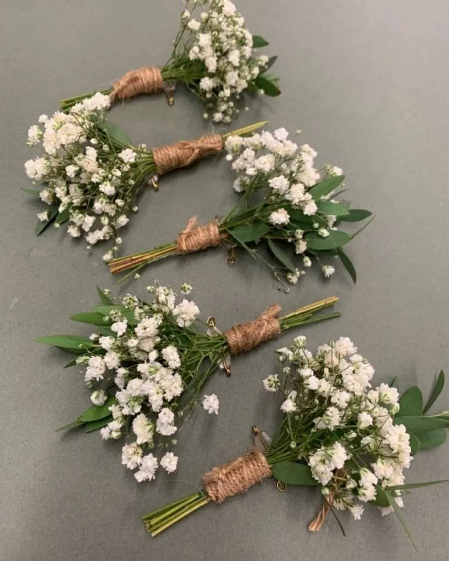 A set of five matching baby breath boutonnieres with twine wrapping — handcrafted by Bloom & Beyond in Lahore