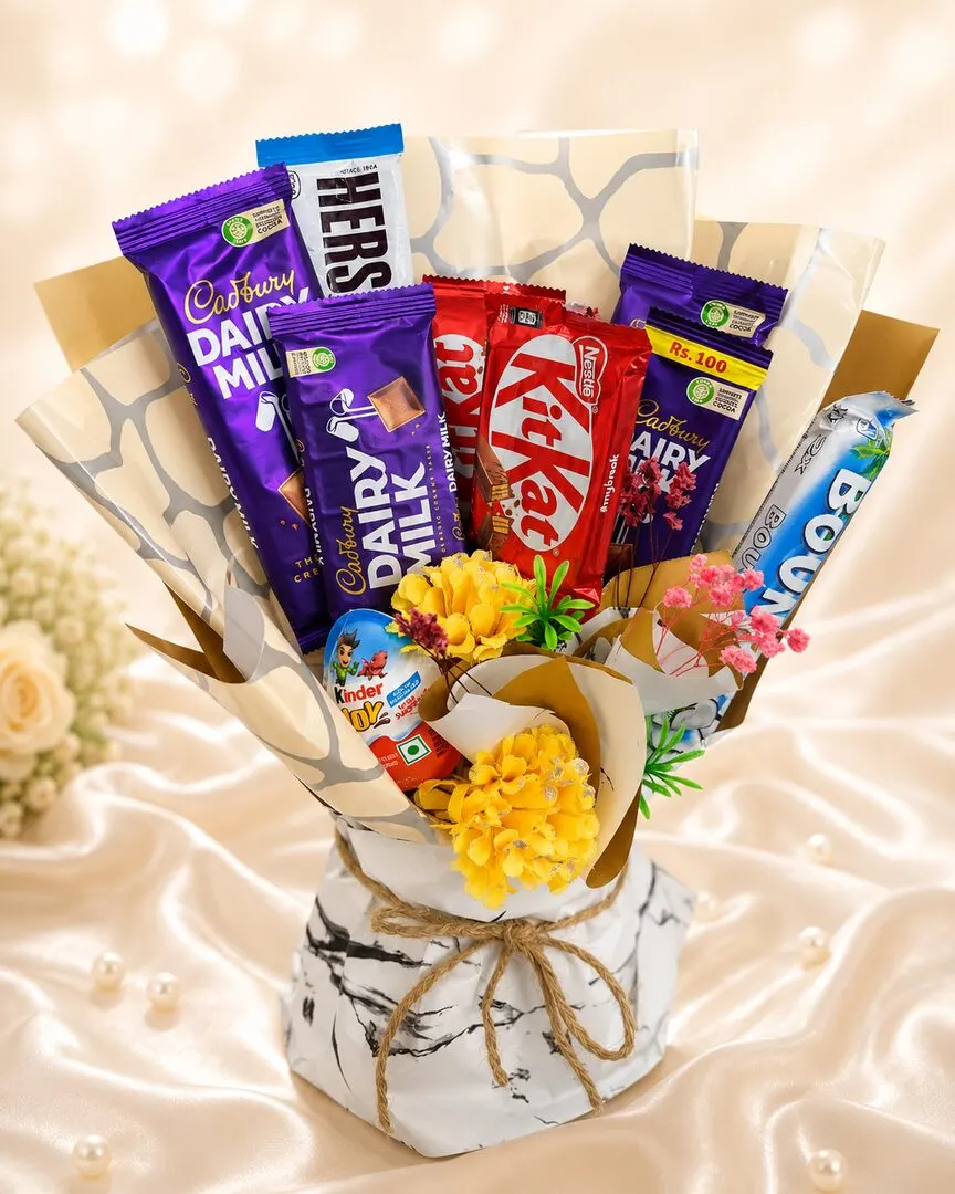 A generous chocolate bouquet of Cadbury Dairy Milk, Hershey's, KitKat, Bounty, Kinder and Perk, arranged with cheerful yellow blooms and baby's breath — handcrafted by Bloom & Beyond in Lahore