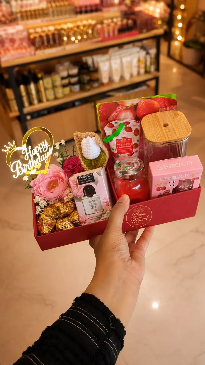 A red birthday gift box with a gold Happy Birthday topper, Ferrero Rocher chocolates and a reusable tumbler — handcrafted by Bloom & Beyond in Lahore