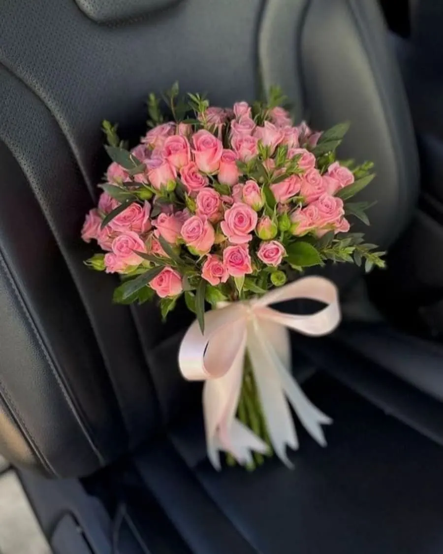 Clusters of delicate pink spray roses tied with a statement ribbon bow — handcrafted by Bloom & Beyond in Lahore