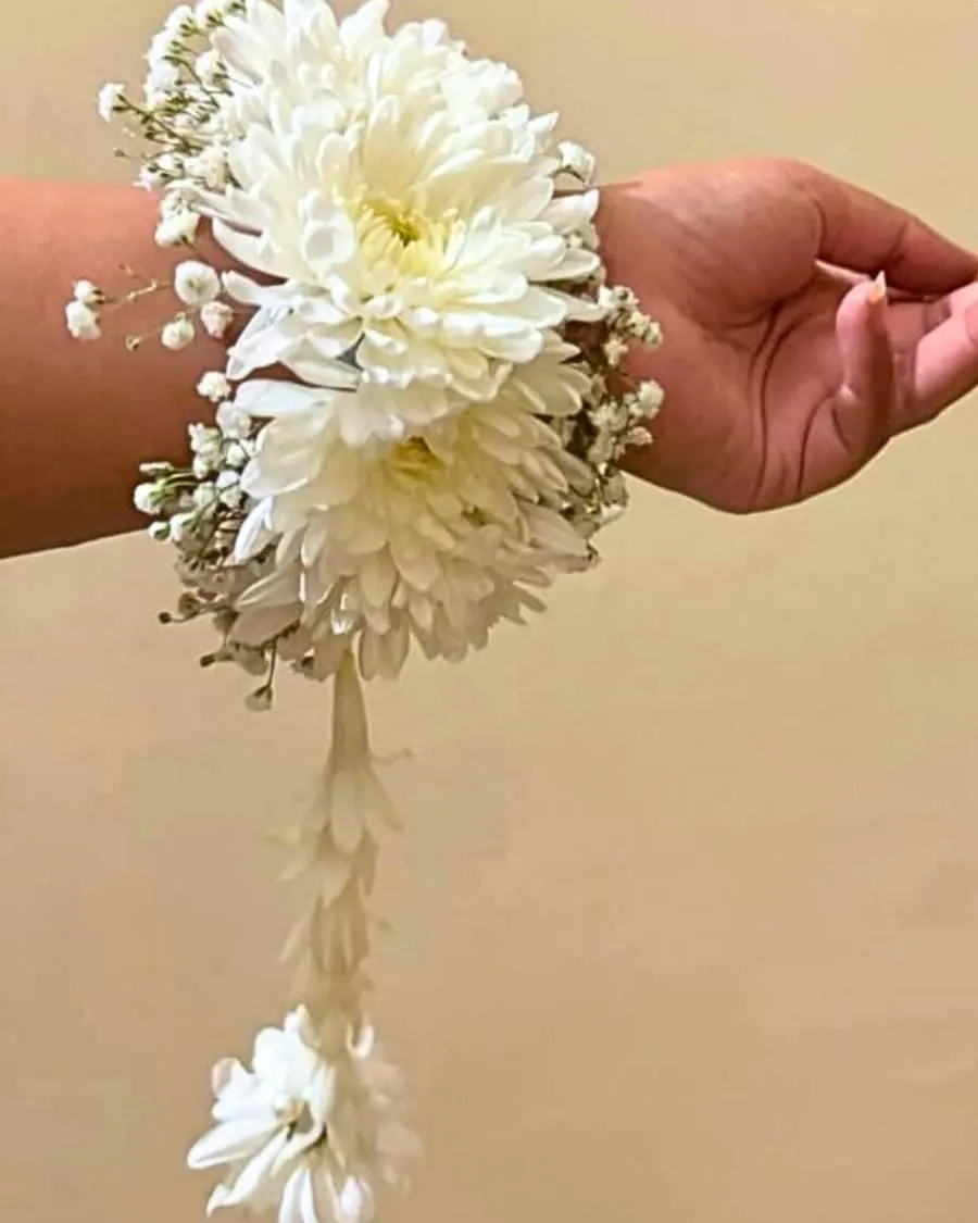 A fresh white chrysanthemum wrist corsage on a comfortable elastic band — handcrafted by Bloom & Beyond in Lahore