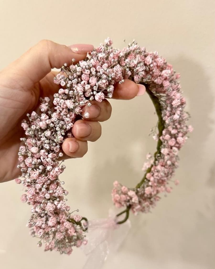 A soft pink baby breath flower crown on a flexible headband — handcrafted by Bloom & Beyond in Lahore