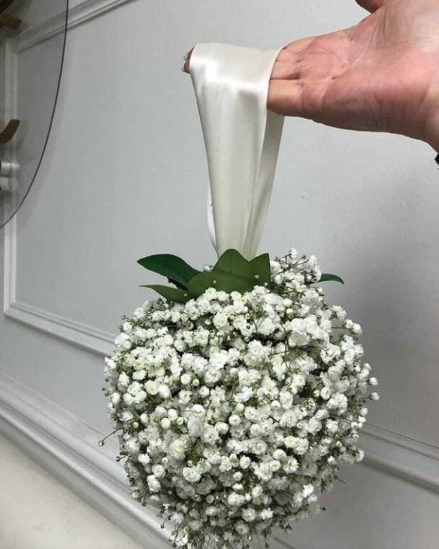 A charming sphere of white baby breath — also known as a pomander or kissing ball — handcrafted by Bloom & Beyond in Lahore
