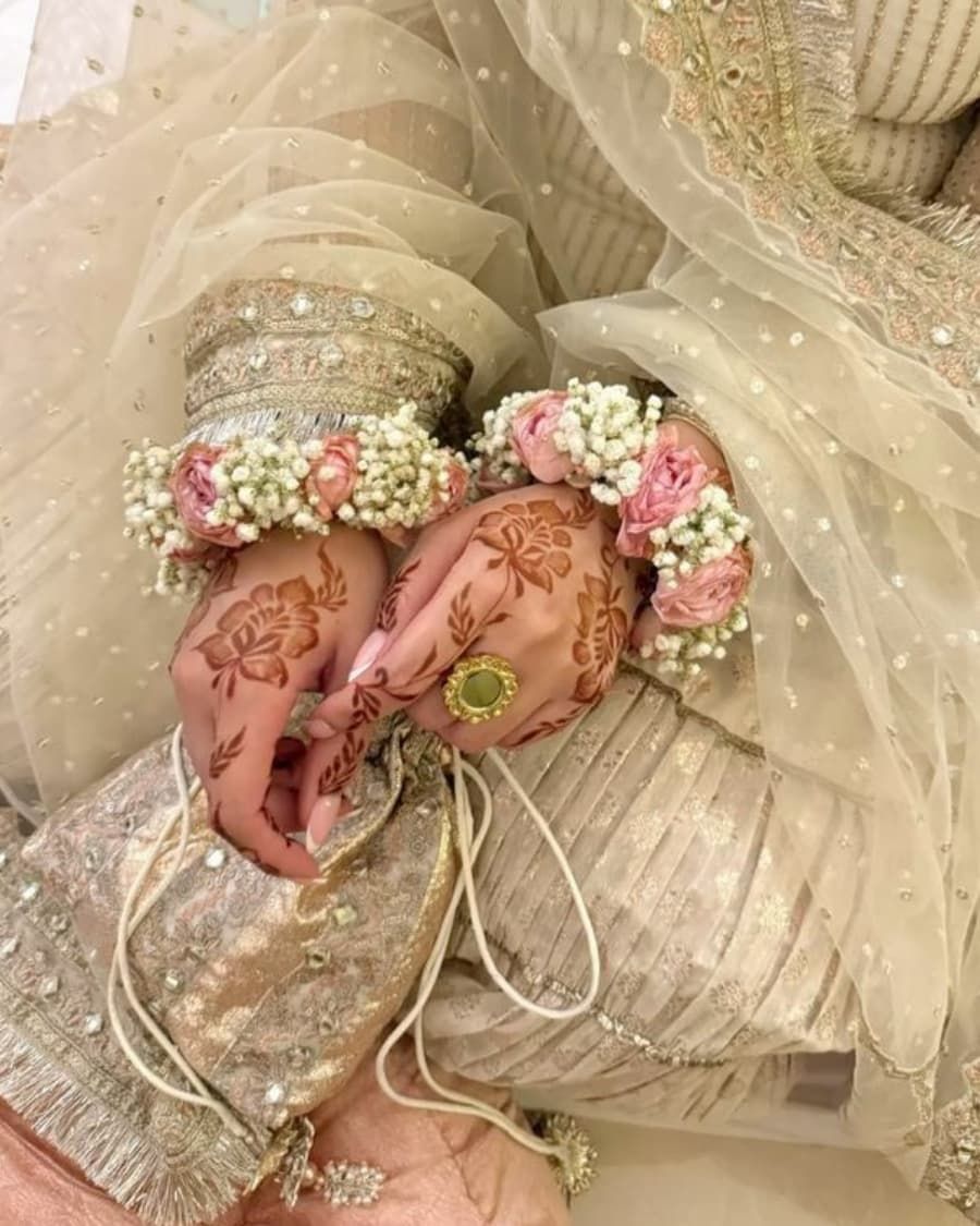 Statement floral bangles with pink roses and baby breath on a flexible base — handcrafted by Bloom & Beyond in Lahore