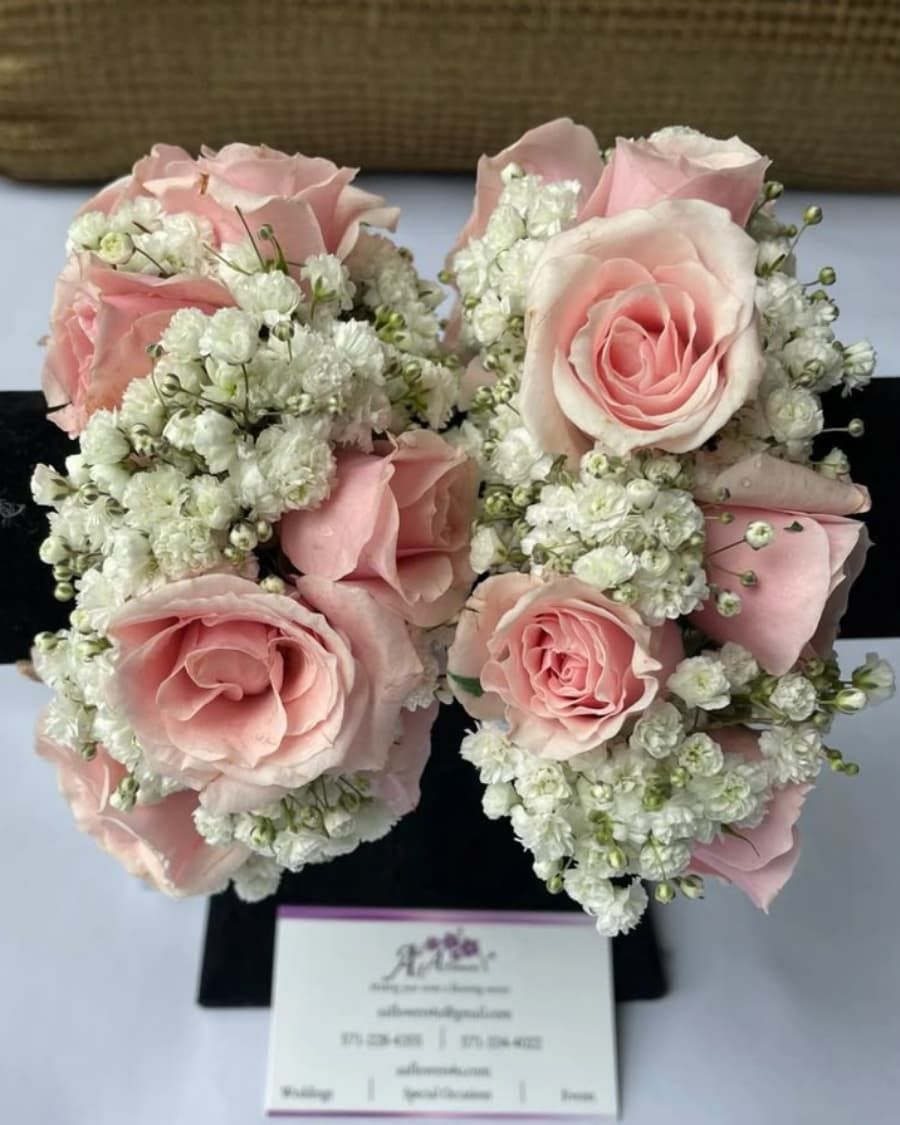 A matching set of three bridesmaid bouquets — pink roses with baby breath, wrapped in coordinating ribbon — handcrafted by Bloom & Beyond in Lahore