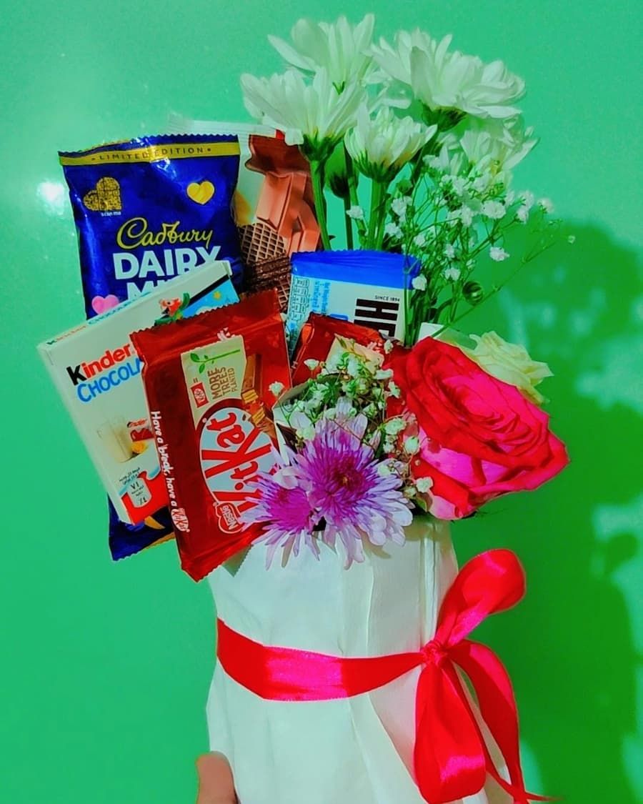 A stunning chocolate bouquet decorated with fresh flowers and Eid-themed ribbons — handcrafted by Bloom & Beyond in Lahore