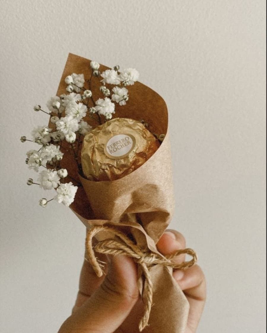 A Ferrero Rocher chocolate nestled in a baby breath mini bouquet cone — handcrafted by Bloom & Beyond in Lahore