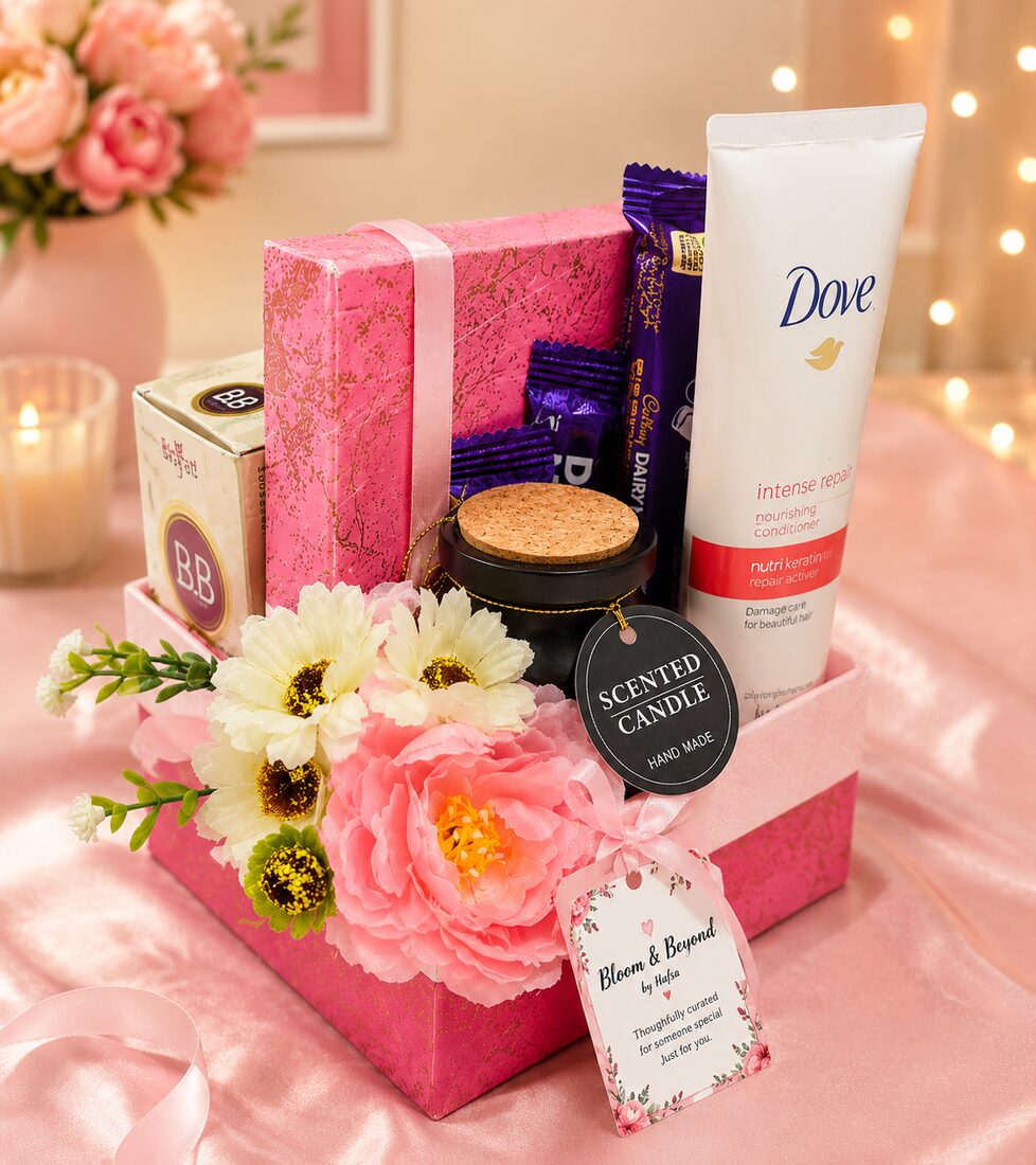 A pink self-care hamper of Dove hair care, a boutique perfume, Cadbury chocolates, a hand-poured scented candle — handcrafted by Bloom & Beyond in Lahore