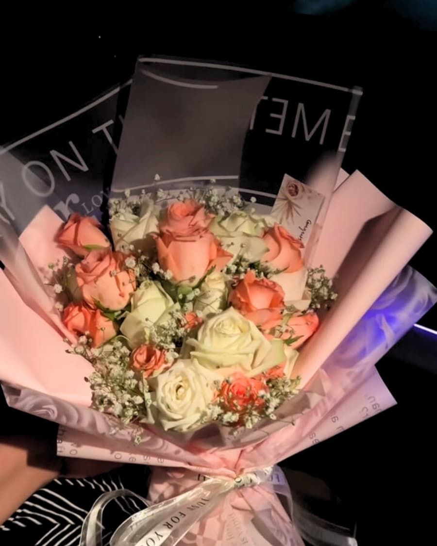 A premium bouquet of peach and white roses with baby breath, hand-arranged in elegant wrapping — handcrafted by Bloom & Beyond in Lahore