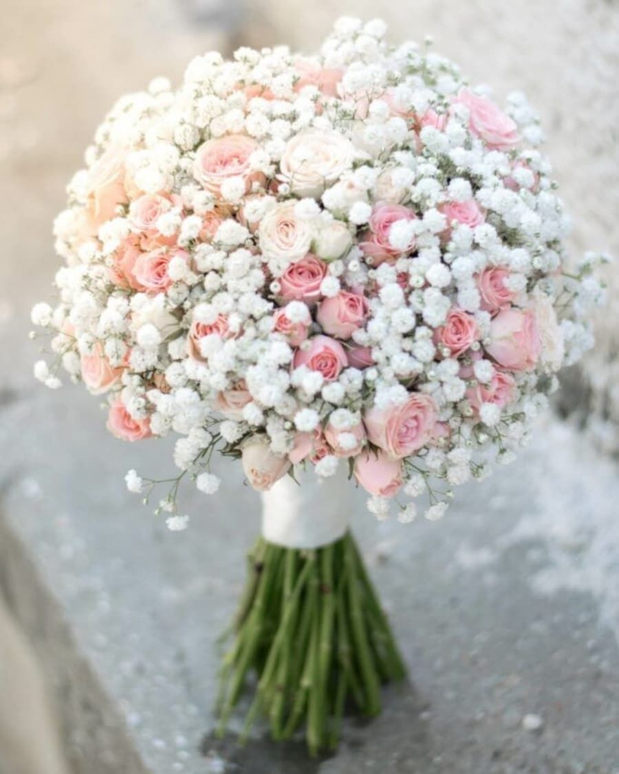 Soft blush and peach roses with baby breath in a romantic hand-tied bridal bouquet — handcrafted by Bloom & Beyond in Lahore