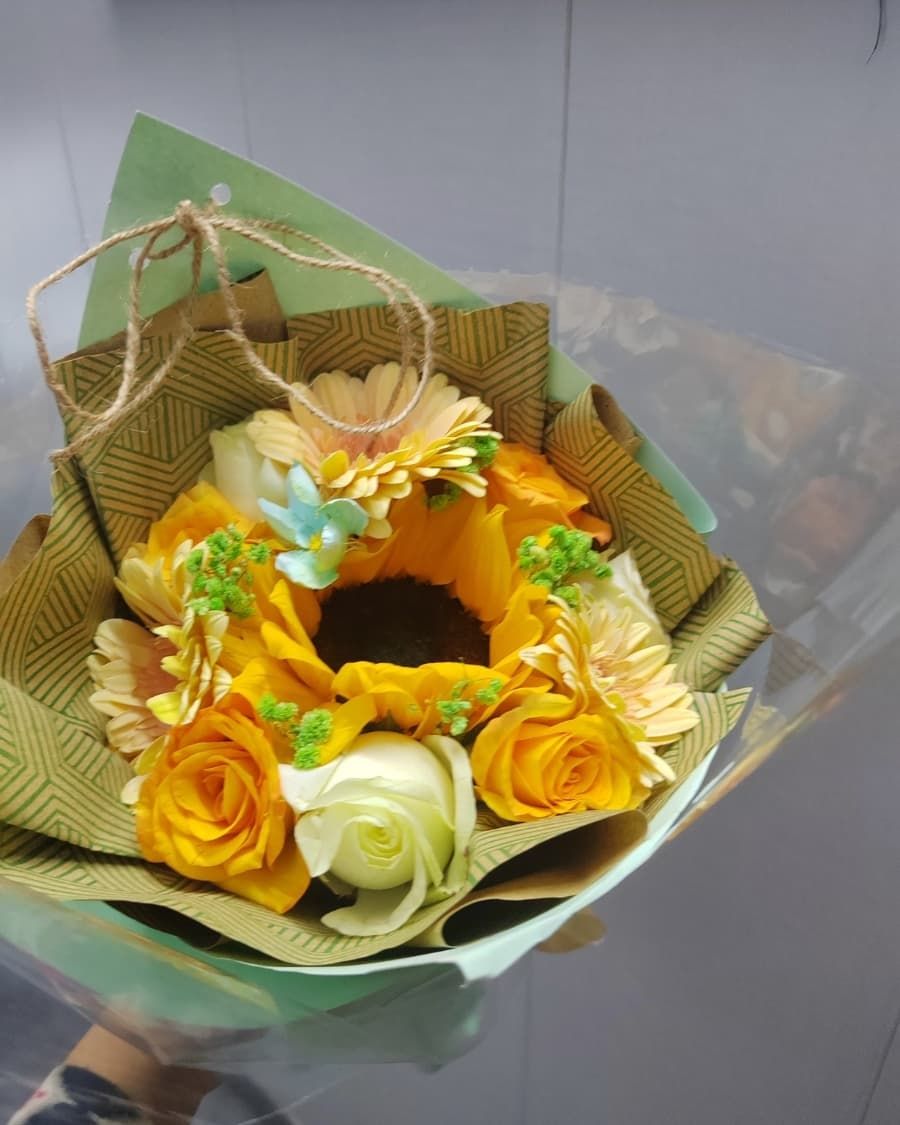 A warm, vibrant bouquet combining sunny yellow sunflowers with orange roses — handcrafted by Bloom & Beyond in Lahore