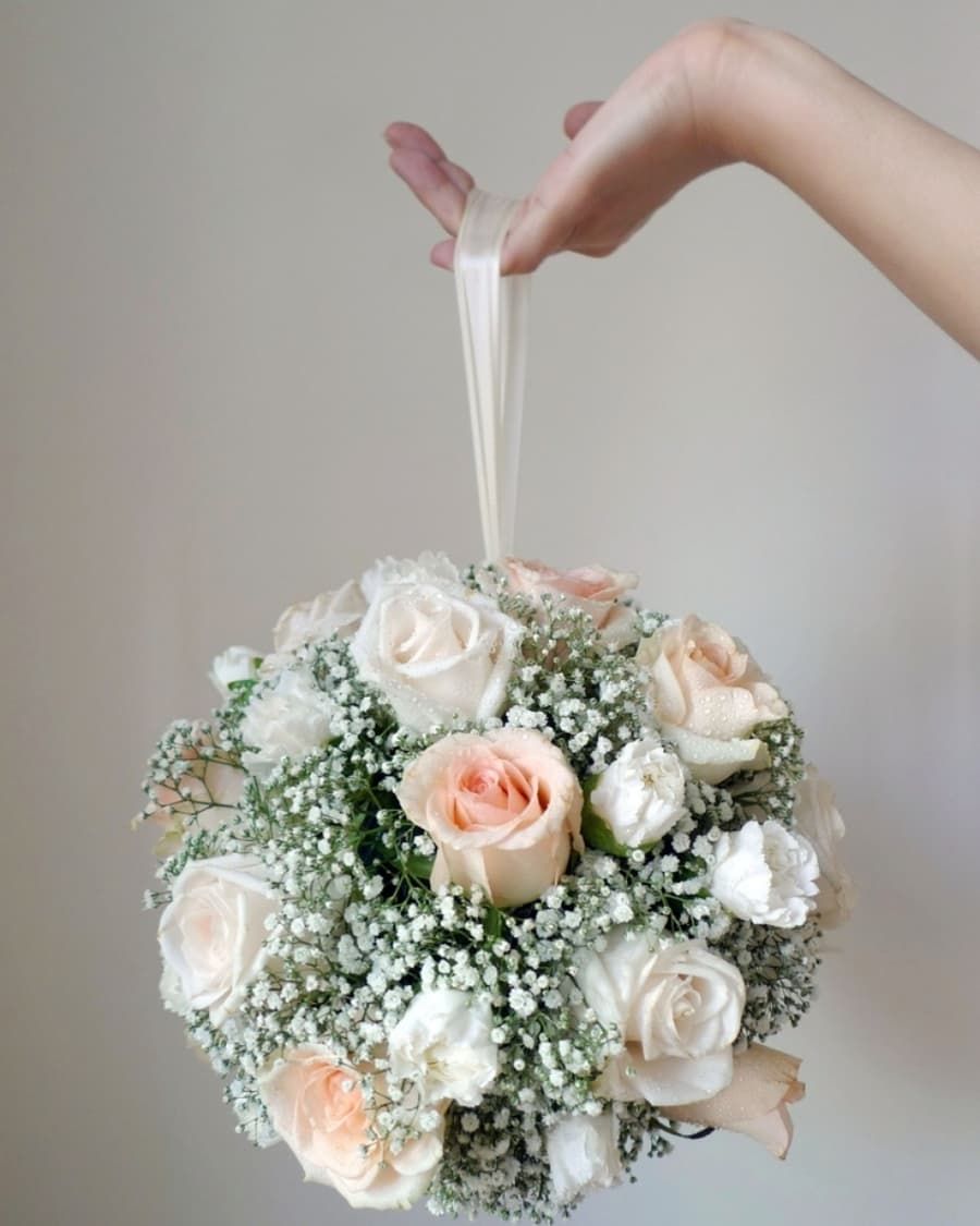 A stunning white rose and baby breath flower ball on a ribbon — handcrafted by Bloom & Beyond in Lahore