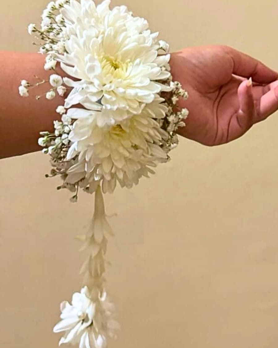 A fresh white chrysanthemum wrist corsage on a comfortable elastic band — handcrafted by Bloom & Beyond in Lahore